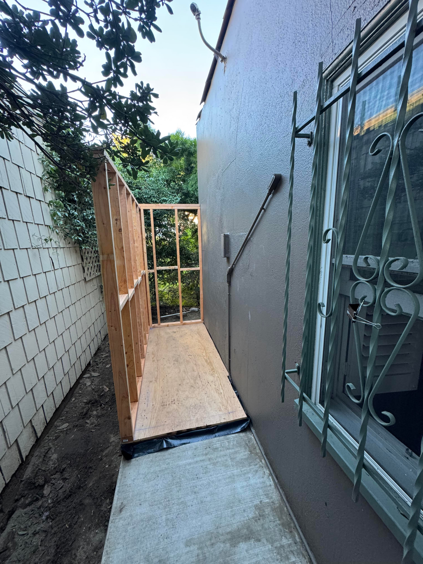 Custom side-yard shed framed in wood on a new plywood floor