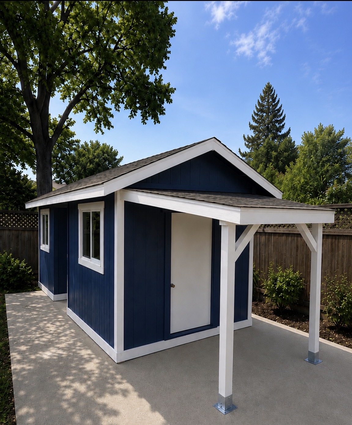 Navy blue custom shed with white trim and covered patio overhang